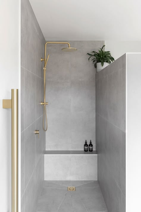 Modern Barnhouse Airbnb Offers Panoramic New Zealand Views | ABI Interiors Grey Tile Bathroom With Gold Fixtures, Modern Bathroom Large Tile, Brass And Grey Bathroom, Abi Brushed Brass Bathroom, Medium Size Bathroom Tiles, Grey And Bronze Bathroom, Grey Gold Bathroom Ideas, Gold Bathroom Fixtures Grey Tiles, White Gold Grey Bathroom