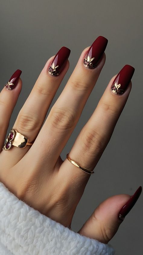 Achieve classy burgundy nails with these dark red design ideas for a polished French tip look From classic black to short and chic explore artful nail designs including chrome and acrylic short nails Get inspired by these elegant burgundy nail design suggestions for a stylish and sophisticated manicure Burgundy And Gold Nails Short, Dark Red Autumn Nails, Red Gel Nails Designs Classy, Deep Red Nails With Gold, Classy Red Nails Design, Fall Red Nails Designs, Burgundy Fall Nails Designs, Dark Red Glitter Nails, Dark Red And Gold Nails