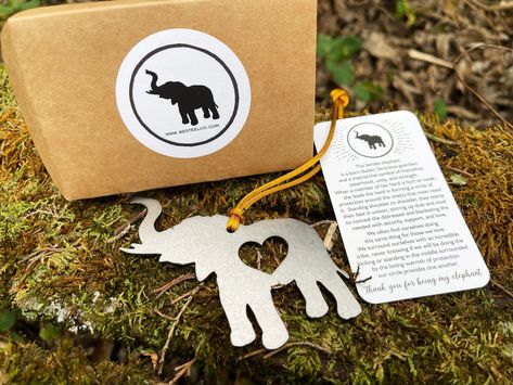 "This raw steel elephant ornament comes gift wrapped in a heavy duty kraft paper envelope with a card explaining the story behind the ornament. The card reads: The female elephant is a born leader, ferocious guardian, and a matriarchal symbol of friendship, sisterhood, unity, and strength. When a member of her herd is hurt or weak, she leads the herd in forming a circle of protection around the one(s) that most need it. Standing shoulder to shoulder, they stamp their feet in unison, stirring up Circle Of Protection, Female Elephant, Born Leader, Circle Images, Symbol Of Friendship, Elephant Ornament, Friendship Symbols, Heirloom Gifts, Memorial Ornaments