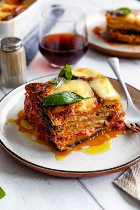 Eggplant Parmesan or Melanzane Alla Parmigiana is a tasty Italian vegetarian meal. Fried eggplants baked with tomato sauce and three types of cheese. Eggplant Parmigiana Italian, Authentic Italian Eggplant Parmesan, Eggplant Parmesan Italian Style, Eggplant Melanzane Recipe, Parmegiana Eggplant, Italian Food Vegetarian, Melanzane Parmigiana Recipes, Eggplant Tomato Recipes, Pasta Norma Recipe