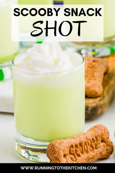 This Scooby Snack Shot is the perfect nostalgic party drink! Made with Midori melon liqueur, coconut rum, pineapple juice, and cream, this vibrant Scooby Snack drink will bring back memories of Saturday morning cartoons. Top the Scooby shot recipe with whipped cream and a Scooby Snack graham cracker for a fun, playful touch. Easy to make and perfect for any gathering, this Scooby Snack Shot will have everyone talking and reminiscing about their favorite childhood moments! Scooby Snack Shot Recipes, Scooby Snack Drink, Scooby Snack Shot, Easy Shot Recipes, Spooky Halloween Recipes, Midori Melon, Spooky Halloween Food, Graham Cracker Cookies, Melon Liqueur