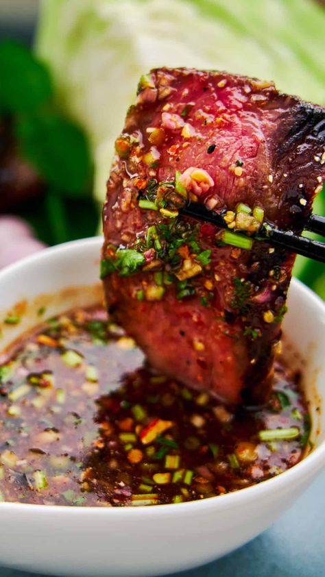 Dipping a medium rare slice of Crying Tiger Beef in spicy Nam Jim Jaew, a spicy tangy and savory Thai BBQ sauce that's addictively good. Crying Tiger Beef, Grilled Beef, Asian Foods, Asian Cooking, Beef Dishes, Asian Dishes, Thai Food, Asian Inspired, Bbq Recipes