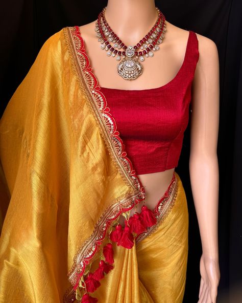 Golden yellow mettalic tissue saree with contrast red golden lace all over sarees. Comes with beautiful big red thread tassels on pallu. Blouse: running blouse 80cm. To find this product in website: Www.thejacouture > Tissue sarees>Golden yellow mettalic tissue saree. Jewellery collaboration: @sruthis_jewellery #mettalictissuesaree #fancysaree #tissuesaree #trendingsaree #tissuelacesaree #goldenyellow Red Blouse Contrast Saree, Yellow Saree With Red Blouse, Golden Saree With Contrast Blouse, Yellow Saree With Contrast Blouse, Contrast Saree, Saree With Contrast Blouse, Tissue Sarees, Thread Tassels, Golden Saree