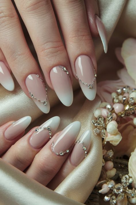 Elevate your nail game this season with these stunning almond nails adorned with delicate rhinestones. This chic design pairs perfectly with any outfit, making it a versatile choice for a night out or a casual day. The fusion of the almond shape with sparkling rhinestones creates a classy look that’s both pretty and edgy. Embrace this trendy style for Fall, and enjoy the fun of flaunting your nails! #AlmondNails #NailDesigns #NailInspo #TrendyNails Almond Shape Elegant Nails, Classy Gem Nails, Simple Gem Designs On Nails, Elegant Nails With Rhinestones, Nails With Gems On Them, Almond Nails Gems, Almond Nails With Bling, Winter Nails With Rhinestones, Delicate Nails Classy