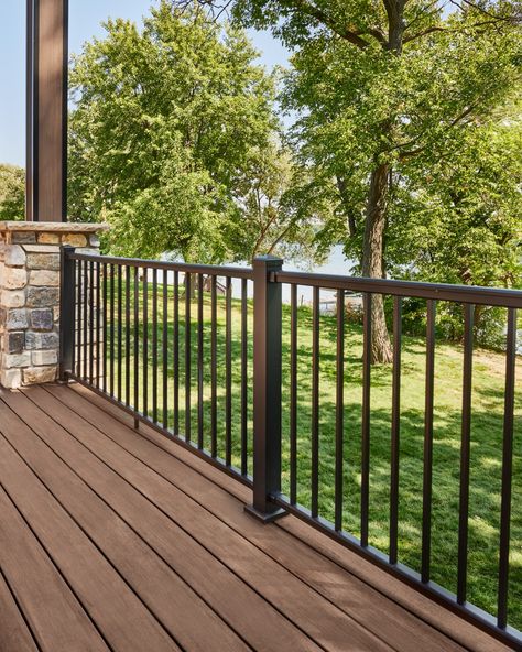 Delivering a sleek design and stylish wrought-iron-inspired appearance, our Impression Rail Express aluminum railing adds design variety and helps bring your entire outdoor oasis together. Browse our customizable options on our website. Outdoor Patio Railing Ideas, Black Metal Railings Outdoor, Wrought Iron Deck Railing, House Railings Outdoor, Black Porch Railing Ideas, Iron Railings Outdoor Balconies, Metal Railings Outdoor, Railings For Stairs Outdoor, Balustrade Ideas Outdoor