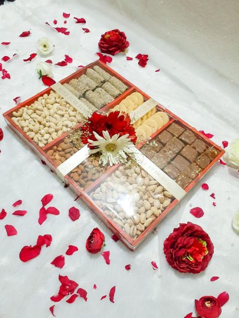 A gift hamper made with rich dry fruits and nuts for engagement, wedding or party events. Link for tray with compartments given below: https://www.amazon.in/MosQuick%C2%AE-Divided-Appetizer-Compartments-Platters/dp/B0C1BY12MS/ref=sr_1_53?crid=2T8XCHVU8T0EW&keywords=tray+with+compartments&qid=1687679616&sprefix=tray+with+compartment%2Caps%2C202&sr=8-53 Dry Fruits Packing Ideas Gift Basket, Nuts Hamper, Dry Fruits Hamper, Engagement Packing Ideas For Bride, Fruits Hamper, Engagement Packing, Dry Fruit Basket, Arabic Baby Names, Fruit Hampers