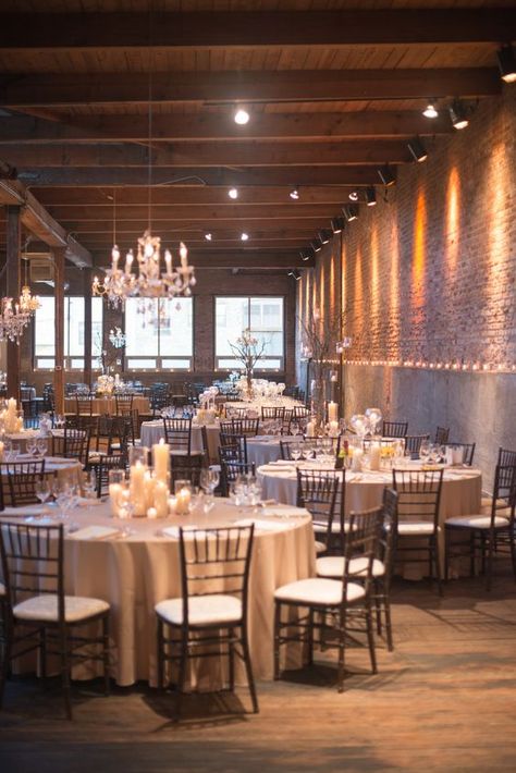 a loft with exposed brick walls and concrete is made softer with lots of candles and some glam chandeliers Chicago Decor, Wedding Venues Chicago, Wedding Venue Ideas, Chic Wedding Venues, Bridal Aesthetic, Venue Lighting, Simple Table Settings, Michigan Wedding Venues, Loft Wedding