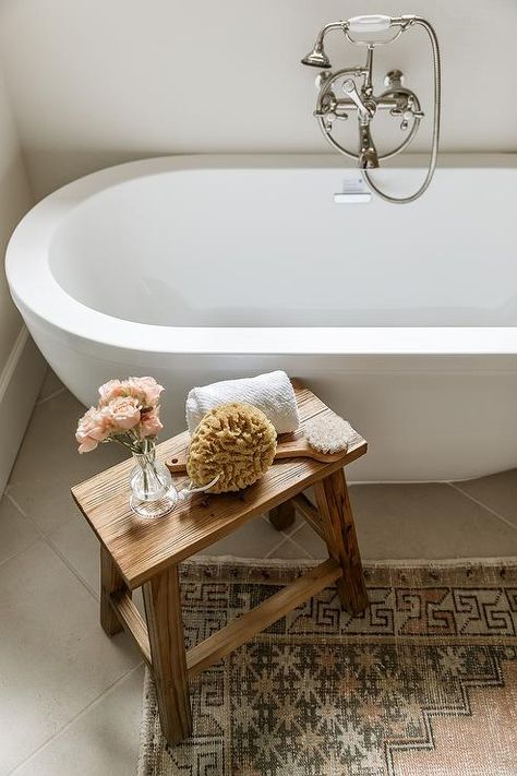 Rustic tub stool sits on a vintage pink and gray rug next to a white oval bathtub with a nickel hand held floor mount filler. Bathroom Stool Styling, Bathroom Bench Ideas, Kelsey Leigh Design Co, Kelsey Leigh Design, Pink And Grey Rug, Standing Tub, Bath Stool, Relaxing Bathroom, Rustic Stools