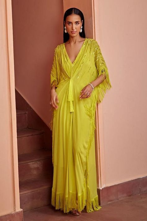 Limoncello kaftan with bead embellishments and fringe details in crepe base. Components: 1 Pattern: Embroidered Type Of Work: Bead, Fringe Neckline: V Neck Sleeve Type: Asymmetric Fabric: Crepe Color: Yellow Other Details:  Note: Inner worn by the model is not for sale. Occasion: Mehendi and Haldi - Aza Fashions Lace Designs On Suits, Kaftan Pattern, Cozy Wardrobe, Kaftan Women, Kaftan For Women, Bead Fringe, Dhoti Pants, Long Kaftan, Yellow Dresses