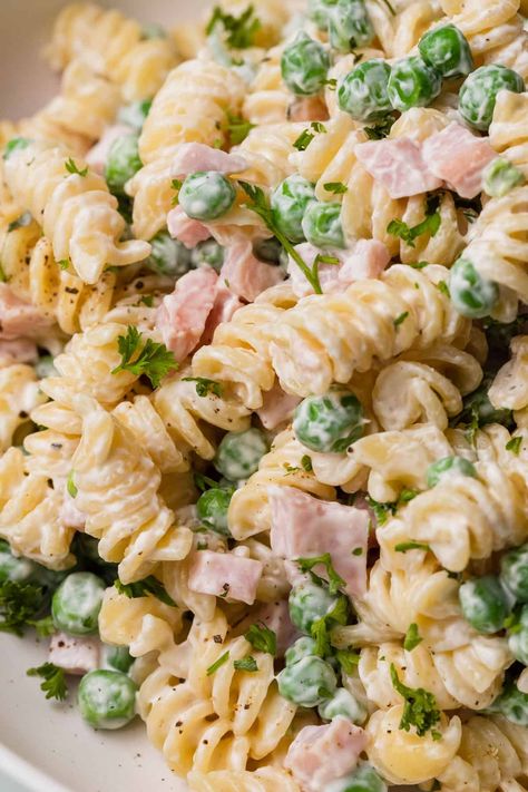 This flavorful Ruby Tuesday ham and pea pasta salad is a delightful addition to any summer gathering or picnic. The combination of tender pasta, savory ham, and sweet peas creates a harmonious blend of flavors and textures that will tantalize your taste buds.The star of this dish is the perfectly cooked rotini pasta, which provides a sturdy base for the other ingredients to shine. The succulent pieces of ham add a rich and smoky flavor that pairs well with the fresh taste of green peas. Pasta Salad With Peas And Cheese, Sweet Pea Pasta Salad, Ham Pea And Cheese Pasta Salad, Easter Pasta Salads Ideas, Cold Ham Salad, Tuna Pasta Salad With Peas, Pasta Ham Salad Recipes, Pasta Salad Rotini, Pea And Pasta Salad Recipes