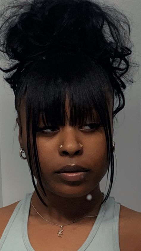 Space Buns With Bangs Black Women, Low Ponytail Bangs, Fringe Bun Hairstyles, Messy Bun Hairstyles With Bangs, Ponytail With Fringe Bangs, Wispy Bun Updo, Chinese Bangs With Ponytail, Bun With Chinese Bangs Black Women, Bang Updo Black Women