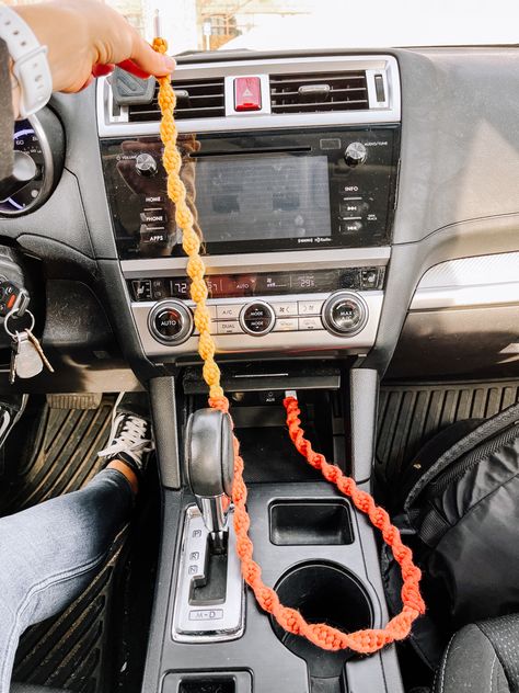 A bright-colored macrame phone charger plugged into the USB port inside a car. Color of phone charger is called sunburst which is an ombré style of red fading to yellow Boho Car Ideas, Diy For Car Decor, Cute Car Inside Decor, Car Inspo Interior Boho, Artsy Car Interior, Car Decorations Crochet, Car Decorations Interior Boho, Cozy Car Interior Ideas, Boho Car Aesthetic