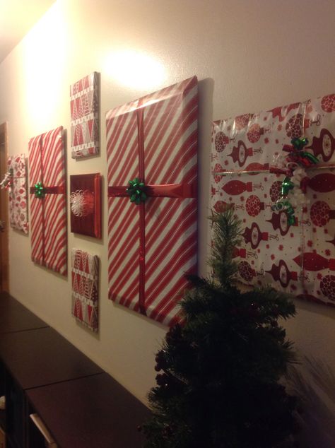 DIY Home Decorations for the holidays. Covered current wall pictures with wrapping paper and bows. Simple Office Holiday Decorations, Wall Decor Garland, Wrapping Paper Pictures Wall Art, Christmas Door Wrapping Paper, Wrapping Paper Wall Christmas, Wrap Pictures On Wall For Christmas, Teachers Lounge Christmas Decor, Wrapping Paper Door Decoration, Christmas Wrapping Paper Wall