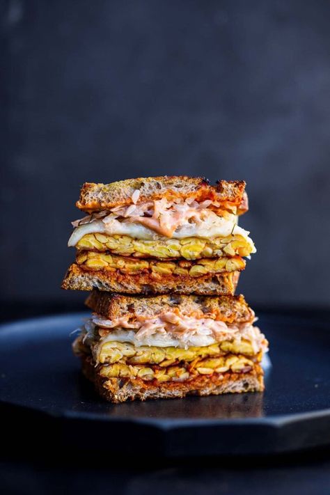 This toasty Tempeh Reuben Sandwich is so delicious! Made with seasoned tempeh, fermented sauerkraut, melty cheese, and classic Reuben sauce, keep it vegetarian or use vegan cheese for a vegan Reuben! Vegan-adaptable. Reuben Sauce, Tempeh Reuben, Vegan Reuben, Crispy Tempeh, Sauerkraut Sandwich, Fermented Sauerkraut, Feasting At Home, Reuben Sandwich, Vegetarian Sandwich