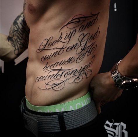 Side Stomach Tattoos For Guys, Mens Rib Tattoo, Chest Tattoo Writing, Chest Tattoo Lettering, Mens Side Tattoos, Side Body Tattoos, Rib Tattoo Quotes, Side Stomach Tattoos, Lower Stomach Tattoos