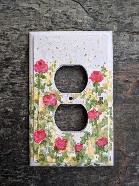 Outlet Painting Ideas Easy, Decorative Electrical Outlet Covers, Outlet Painting Ideas, Outlet Covers Painting, Painting Outlets, Painted Outlets, Light Switch Art, Light Switch Covers Diy, Pink Floral Wall