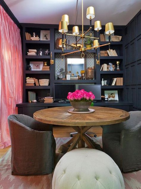 Home office features a wall of navy built-in shelves over a navy built-in desk facing a round trestle table lined with gray slipcovered chairs illuminates by a Jonathan Adler Ventana 2 Tier Chandelier atop a pink herringbone rug across from pink silk curtains. Reading Room Design, Piano Library, Glam Dining Room, Home Library Decor, New York Brownstone, Genevieve Gorder, Office Den, Asian Homes, Office Library