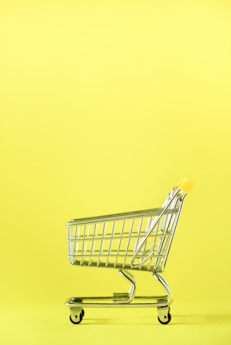 Shopping cart on yellow background. shop trolley at supermarket. sale, discount, shopaholism concept. consumer society trend Premium Photo | Free Photo Shopping Cart Logo, Cart Logo, Yellow Aesthetic Pastel, Minimal Photo, Shopping Trolley, Food Backgrounds, Brand Kit, Yellow Aesthetic, Modern Branding