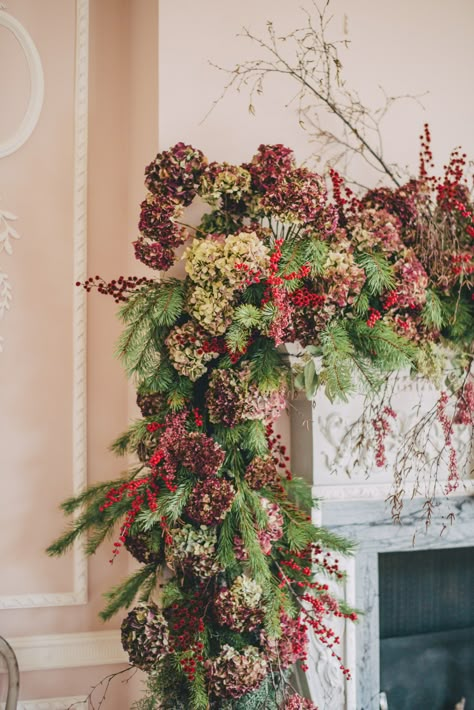 Christmas decorating with plants & foliage | House & Garden Dried Hydrangeas, Christmas Flower Arrangements, Christmas Plants, Christmas Preparation, Winter Plants, Flower Shops, Christmas Mantle, Christmas Mantels, Christmas Fireplace