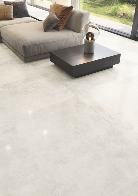 Casalgrande Padana’s Kerinox Bianco lapped tiles embody the reflective nature of metal, brightening this open-plan living area. Floor Tiles Living Room Modern, Living Room Floor Tiles, Room Floor Tiles, Modern Floor Tiles, Tiles Living Room, Laundry Room Tile, Floor Tiles Design, Tile Floor Living Room, Modern Flooring