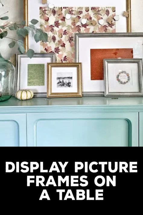 How to Display Picture Frames on a Table Picture Table Display Living Rooms, Photo Display On Table, Table With Framed Photos, Frames On Table Display, How To Display Photos On A Table, How To Style Picture Frames On Table, Tabletop Photo Display Ideas, How To Display Family Photos On Tables, Picture Frame Display On Table