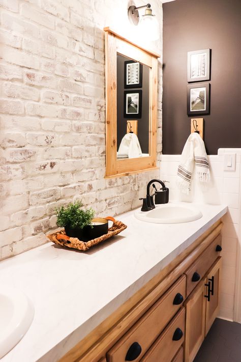 When we made over the boys bathroom, I knew I wanted a showstopper. Here's how to install and limewash brick veneer accent wall. Whitewash Brick Bathroom, Brick Tiled Bathrooms, Faux Brick Wall Bathroom Master Bath, Faux Brick Wall In Bathroom, Painted Brick Bathroom Wall, Brick Veneer Wall Kitchen, Shiplap And Brick Bathroom, Brick Wall In Laundry Room, Limewash Brick Backsplash Kitchen