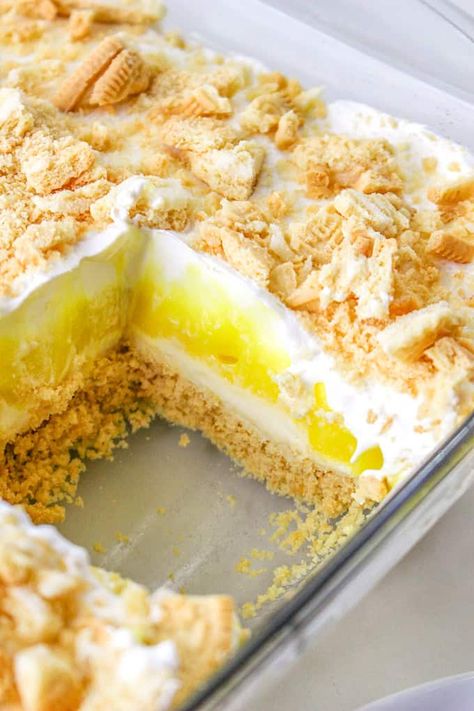 This Lemon Delight is a sweet, creamy no bake lemon dessert with layers of Golden Oreo, sweet cheese, lemon pudding, and whipped cream. Whether you call this recipe Lemon Delight or Lemon Lush, it's going to be a hit this summer! Lemon Pudding Cool Whip Dessert, Heavenly Lemon Oreo Dessert, Four Layer Delight Recipe, Golden Oreo Cheesecake Delight, No Bake Lush Desserts, Lemon Lush Dessert With Golden Oreos, Lemon Delight Dessert, Lemon Lush Cake, Lemon Dessert Recipes Easy Simple