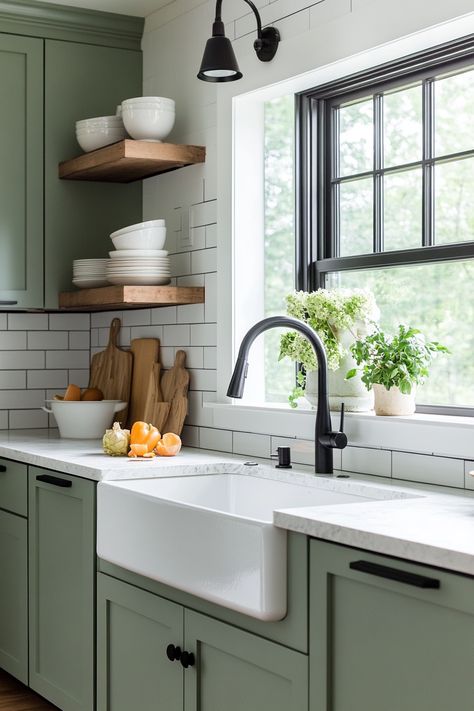 Discover the latest kitchen design trend with this modern farmhouse look! Featuring stylish green cabinetry, open shelving, and a deep farmhouse sink, this space combines functionality and elegance. Perfect for any home makeover! #kitchendesign #farmhousechic #homedecor Stainless Steel Farmhouse Sink Green Cabinets, Green Kitchen Floating Shelves, Olive Green Kitchen Cabinets Farmhouse, Modern Farmhouse Green Kitchen, Green Cabinetry Kitchen, Green Kitchen Black Sink, Farmhouse Sink Green Cabinets, Modern Farmhouse Cabinet Colors, Sage Color Kitchen