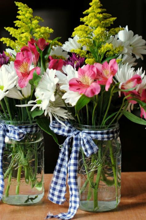 Gingham Scraps Arrangement: This easy-to-make flower arrangement could be your next go-to gift. Just tie a piece of gingham fabric around your Mason jar and add a bouquet. Click through to find more pretty mason jar flower arrangements to try this summer. Flower Arrangements In Mason Jars, Mason Jar Flower Arrangements, Hyacinth Flowers, Mason Jar Flowers, Diy Arrangements, Mason Jar Centerpieces, Trendy Flowers, Deco Floral, Mason Jar Diy