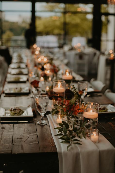 Wedding Table Decor with Cheesecloth Runner and Greenery Arrangements with Floating Candle Centerpieces Candle Runner Centerpiece, Rustic Wedding Candles, Autumnal Wedding Table Decor, Table Setting Fall Wedding, Floating Candles And Flowers Centerpiece, Mason Jar Candle Centerpieces, Fall Wedding Centerpieces Candles, Floating Candle Centerpieces Long Table, Minimal Fall Wedding Decor