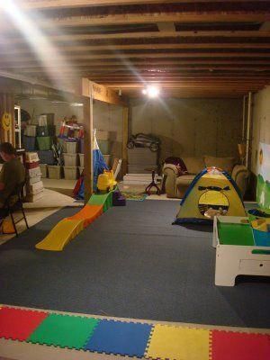 Basements are like extra rooms. They can be used for storing things and if you’re a horror movie character, basements can be used to tie up innocent v... | Create a Children’s Play Area #unfinishedbasement #unfinishedbasements #basement #basements #decoratedlife Unfinished Basement Playroom, Basement Play Area, Basement Playroom Ideas, Garage Playroom, Unfinished Basement Ideas, Basement Layout, Basement Remodel Diy, Basement Redo, Basement Gym