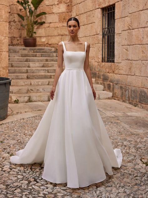 If it’s classic elegance you’re searching for, the Moonlight Tango T133 wedding dress is a luxe choice for your big day. Constructed in organza and satin fabrics that offer contrasting textures, this exquisite gown has a dreamy, ethereal look and feel that’s fitting for a black tie fairytale wedding or a more modern, minimalist event. This design boasts a sleeveless, fitted bodice in smooth satin fabric with a chic square neckline, wide straps that provide comfort and support, and a low scoop Square Neckline Wedding Dress, Organza Wedding Dresses, Wedding Dress Spaghetti Straps, Square Neck Wedding Dress, Bodice Wedding Dress, Dresses For Woman, Wedding Dress Organza, Stylish Wedding Dresses, Aline Wedding Dress