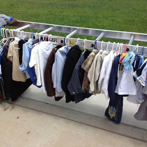 Great idea for displaying clothes at a garage sale! Turn a ladder horizontally and lay each side on a table and hang clothes from both sides! Clothes Rack For Garage Sale, Yard Sale Display Clothes, Garage Sale Hacks, Garage Sale Clothes, Yard Sale Clothes Rack, Yard Sale Clothes, Yard Sale Display, Yard Sale Hacks, Garage Sale Organization