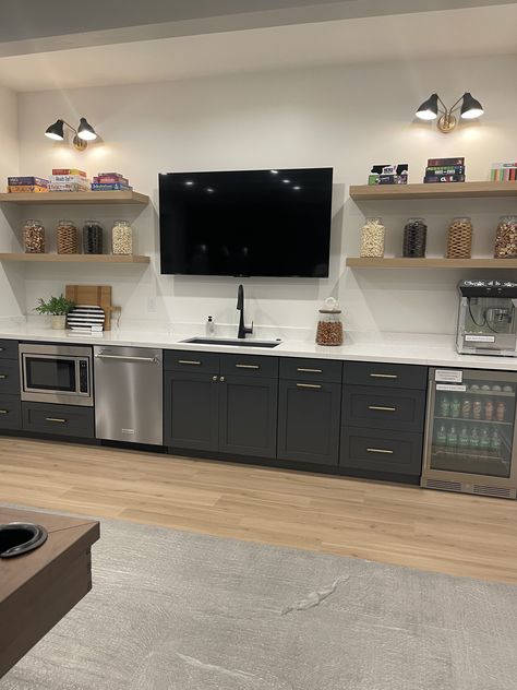 Wet Bar Designs With Tv, Bar With Floating Shelves And Tv, Home Bar With Tv And Shelves, Basement Popcorn Bar, Bar Wall With Tv, Basement Bar With Tv In Middle, Tv And Bar Wall Unit, Small Basement Tv Room, Bar With Tv In Middle