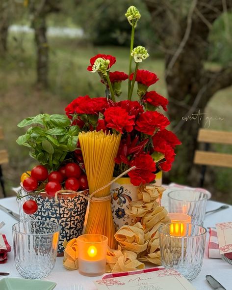 Channeling ultimate Italian vibes with this gorgeous table setup! 🍅🌿 Red carnations paired with fresh basil, tomatoes, chili peppers, and pasta make for a deliciously rustic centerpiece. Perfect for any Italian-inspired dinner party! 🇮🇹✨ #ItalianDining #TableDecor #FoodInspiration #DinnerParty #RusticElegance #eventigaia #weddingplanner #destinationwedding Pasta Bar Decorations, Italian Theme Garden Party, Italian Themed Parties Decorations, Italian Al Fresco Dinner Party, Italian Party Centerpieces, Italian Centerpieces Table Decorations Tuscan Style, Pasta Themed Bridal Shower Ideas, Pasta Bridal Shower Ideas, Pasta Themed Baby Shower Ideas