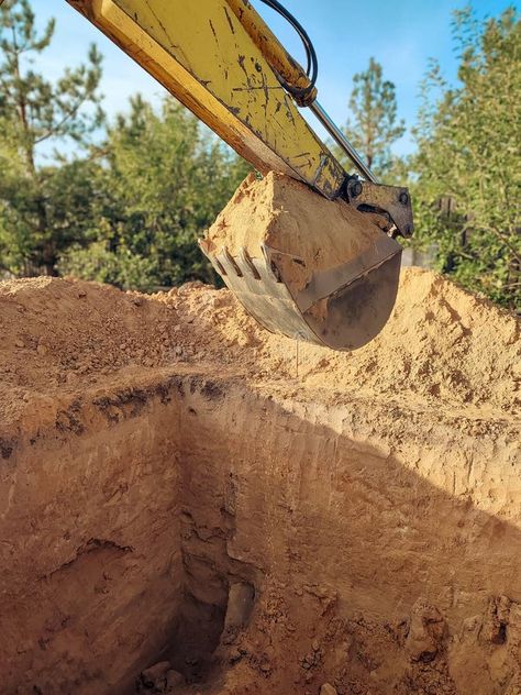 Digging the pit foundation a hole with excavator at the construction site. Excavator digging a hole into the ground royalty free stock photos Digging Being 3, Road Under Construction, Excavation Construction, Post Hole Diggers, Digging Holes, The Pit, Construction Site, Free Stock Photos, Soil