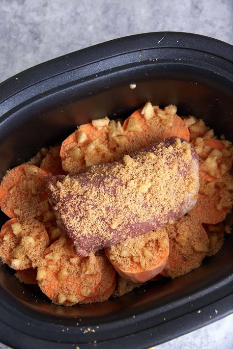 A pork tenderloin on top of cut sweet potatoes in a crock pot. Pork Roast Sweet Potatoes Crock Pot, Crock Pot Apple Pork Tenderloin, Pork With Sweet Potatoes, Pork Loin Sweet Potato Crock Pot, Pork Chop Sweet Potato Recipes Crock Pot, Roast With Sweet Potatoes Crockpot, Crockpot Pork Chops And Sweet Potatoes, Slow Cooker Pork Chops And Sweet Potato, Pork Chops And Sweet Potatoes Crock Pots