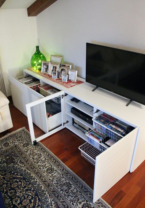 I like this for my top DVD storage - won't hold them all. I could still add the gold accents.   White TV stand IKEA hack with lots of storage Tv Stand Ikea, Stolmen Ikea, Tv Stand Ikea Hack, White Living Room Furniture, Ikea Tv Stand, White Tv Stand, Ikea Tv, Swivel Tv Stand, Best Ikea Hacks