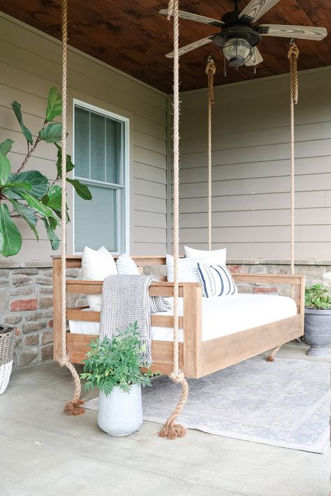 Make your outdoor space extra relaxing with a porch swing bed. Let me show you how to build a porch swing bed with this easy tutorial. Porches With Swings, Porch Hanging Chairs, 2023 Porch Trends, Outdoor Swinging Daybed, Front Porch Swings Ideas, Diy Hanging Day Bed Porch Swings, Day Bed Swings, Pergolas With Swings, Hanging Daybed Outdoor Diy