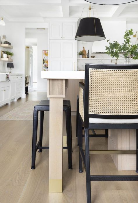 Cane back stools pull up to the dining island crafted with reeded detailing on the top of on its brass-footed legs. Photos by Meagan Larsen. Design by Andrea West Design Island With Legs Kitchen, Island Legs Kitchen, Reeded Kitchen Island, Island Legs Ideas, Kitchen Island Legs Ideas, Reeded Island, Kitchen Island Posts, Kitchen Island With Legs, Kitchen Island Leg