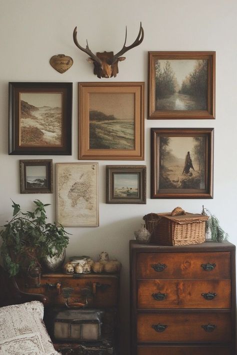 "Curate a Vintage-Inspired DIY Gallery Wall! 🖼️✨ Mix and match frames and artwork for a timeless, eclectic look. Perfect for adding character and charm to your home! 🏡🌟 #GalleryWall #VintageDecor #DIYProjects" Antique Gallery Wall Bedroom, Antique Wall Gallery, Cottage Picture Wall, Vintage Wall Aesthetic, Deer Skull Gallery Wall, Gallery Wall On Wood Paneling, Vintage Wall Art Collage, Gallery Wall Over Bed, Wood Frame Gallery Wall