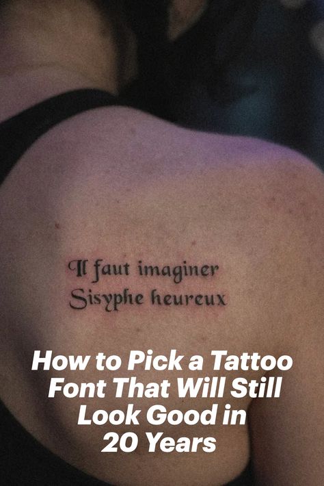 Gabby Pignanelli posing with her back to the camera showing off her tattoo that states, "If fault imaginer sysphe heureux." Where To Put Writing Tattoos, Tattoo Word Ideas Female, Unique Lettering Tattoo, Old English Text Tattoo, Writing Styles For Tattoos, Best Font For Tattoo Lettering, Classic Tattoo Lettering, Old Script Tattoo, Block Letter Tattoo Fonts