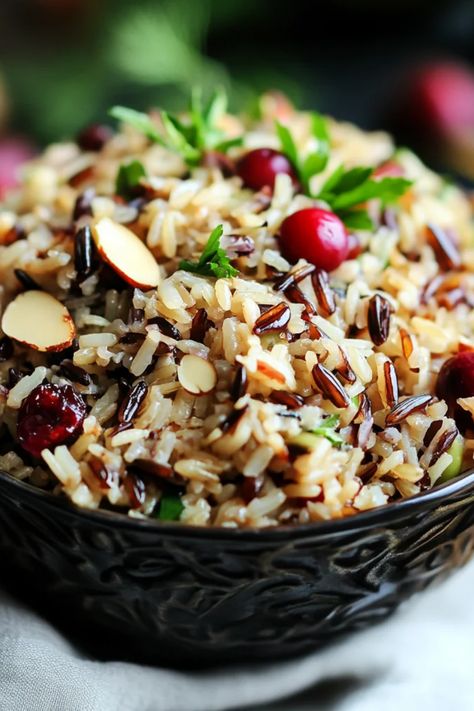 This pin features a colorful bowl of cranberry almond wild rice pilaf, showcasing a delicious holiday side dish perfect for Thanksgiving and special occasions. Rice With Cranberries Recipe, Wild Rice In Crockpot, Wild Rice Sides, Recipes With Wild Rice, Cranberry Rice, Rice In Crockpot, Pilaf Rice, Wild Rice Pilaf, Almond Rice