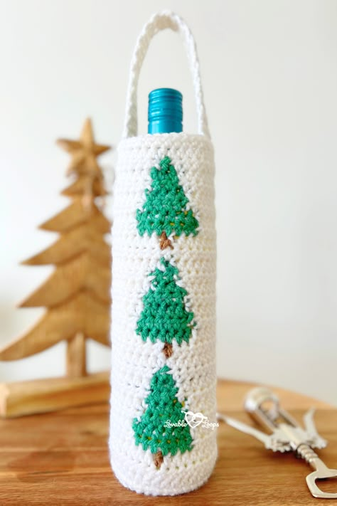 A Christmas crochet wine bottle holder in festive colors and pine trees, designed for the winter season with pine tree inspiration, perfect as a handmade gift or gift bag for wine bottles. Crochet Wine Bottle Holder, Wine Bag Pattern, Wine Cover, Crochet Wine, Christmas Wine Bottle Covers, Bottle Cozy, Christmas Wine Bottle, Bottle Cozies, Christmas Wine Bottles