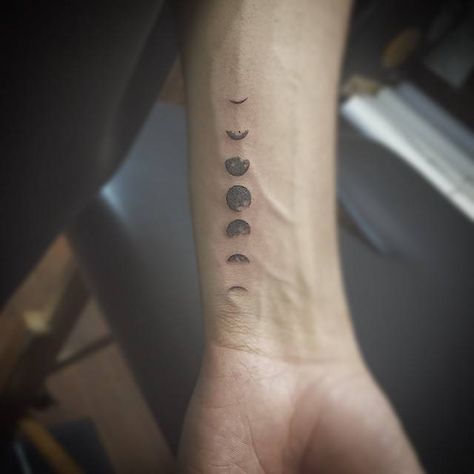 Small black-work style tattoo of moon phases inked on the inner side of the left wrist Astronomy Tattoo, Moon Phases Tattoo, Men's Small Tattoo, Wrist Tattoos For Guys, Small Tattoos For Guys, Phases Of The Moon, Small Tattoo Designs, Little Tattoos, Trendy Tattoos