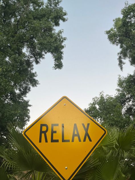 Relax sign surrounded by trees as the blue sky is seen in the background. Chill Vision Board, Chill Background Aesthetic, Chill Asthetic Picture, Relaxing Vibes Aesthetic, Relaxing Vision Board, Relax Mood Aesthetic, Relaxing Asthetic Picture, Summer Chill Aesthetic, Relax Vision Board