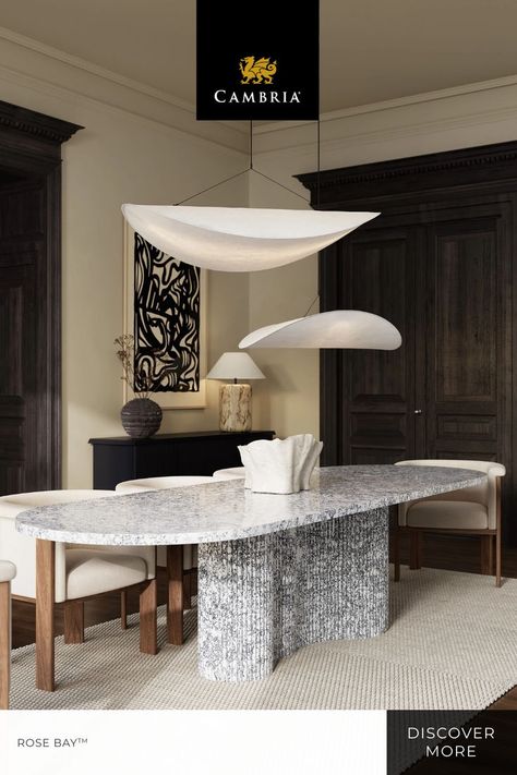 Inspired by the architectural heritage of pre-war NYC, this dining room boasts a beautifully unique design. The quartz dining room table features curved tambour-paneling and a seamless curved top in Cambria Rose Bay, creating a one-of-a-kind dining experience. The modern aesthetic embraces both innovation and design, showcasing how luxury materials can transform traditional settings. Save this post and consider Cambria’s custom applications for your next project. Quartz Dining Table, White Foundation, Cambria Countertops, Quartz Marble, Cambria Quartz, Rose Bay, Luxury Materials, Marble Dining Table, Quartz Colors