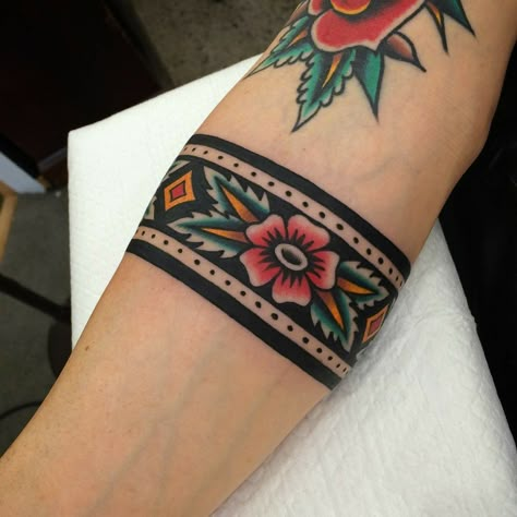 Wrist Tattoos Neo Traditional, Aztec Wrist Band Tattoo, American Traditional Wrist Cuff Tattoo, Traditional Flower Band Tattoo, American Traditional Arm Band, Aztec Tribe Tattoo, Traditional Band Tattoo, Traditional Cuff Tattoo, Traditional Tattoo Band