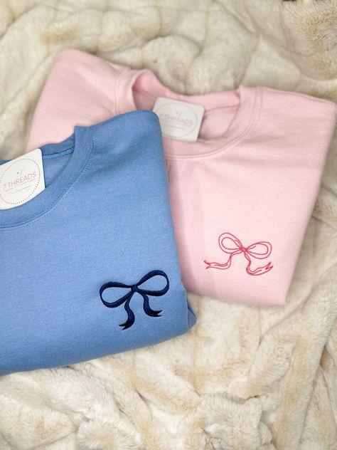 Channel your inner darling with this adorable coquette-inspired sweatshirt, featuring a delicate embroidered bow on the upper left chest. This soft and cozy crewneck is perfect for layering or wearing on its own, adding a touch of sweetness and femininity to any outfit. Available in a variety of colors to suit your style, this sweatshirt is sure to become a staple in your wardrobe. Features: Soft and comfortable unisex fit Embroidered coquette bow detail Choose your thread color This sweatshirt Cute Crew Neck Sweatshirt For Gift, Cute Embroidered Sweatshirt Gift, Cute Embroidered Sweatshirt For Loungewear, Coquette Crewneck, Crewneck Sweatshirt Outfit, Coquette Stuff, Coquette Things, Sweet Shirts, Bow Sweatshirt