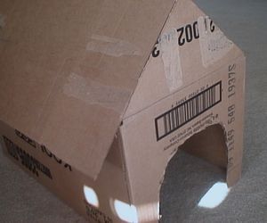 How to Make a Cardboard Doghouse. I can think of so many ways I could use this in therapy Cardboard Doghouse, Cardboard Dog House, Doghouse Diy, Cardboard Dog, Punch Game, Pet Study, House Truck, Pet Theme, Snoopy Party